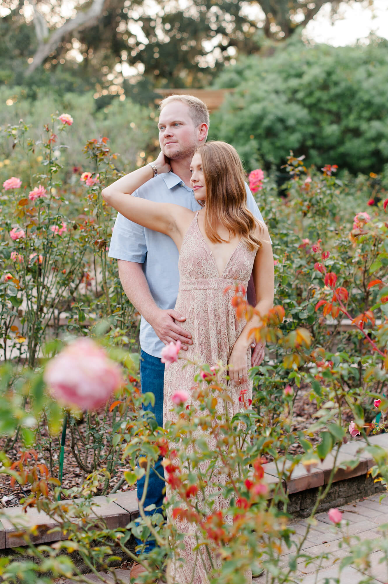 Couple stands in the gardens at this beautiful park posing during their engagement session Washington Oaks Gardens State Park