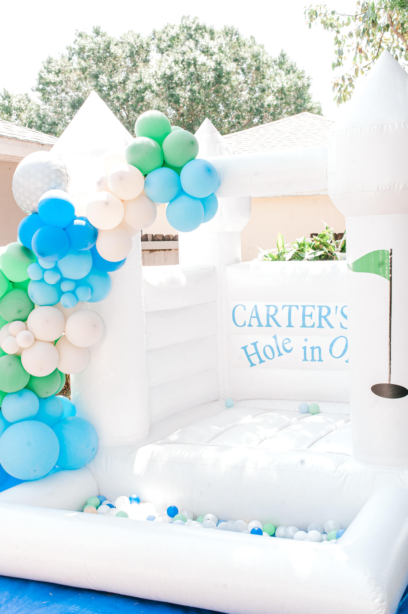 The cutest white castle bounce house party rental for this birthday party.