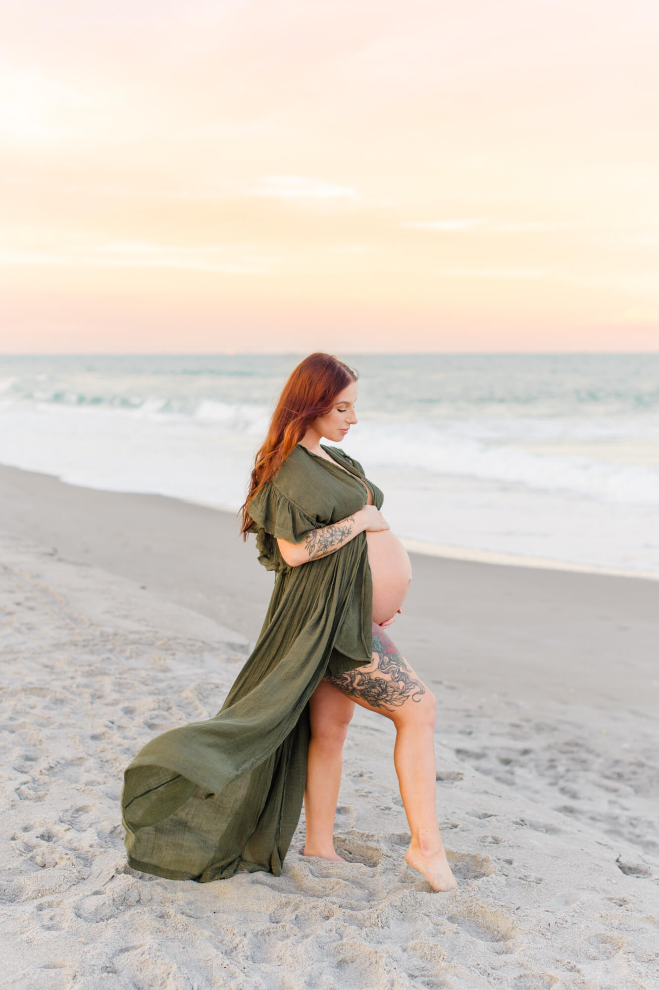 Beautiful mother on the beach at sunset wearing a green maternity dress from the Client Closet.