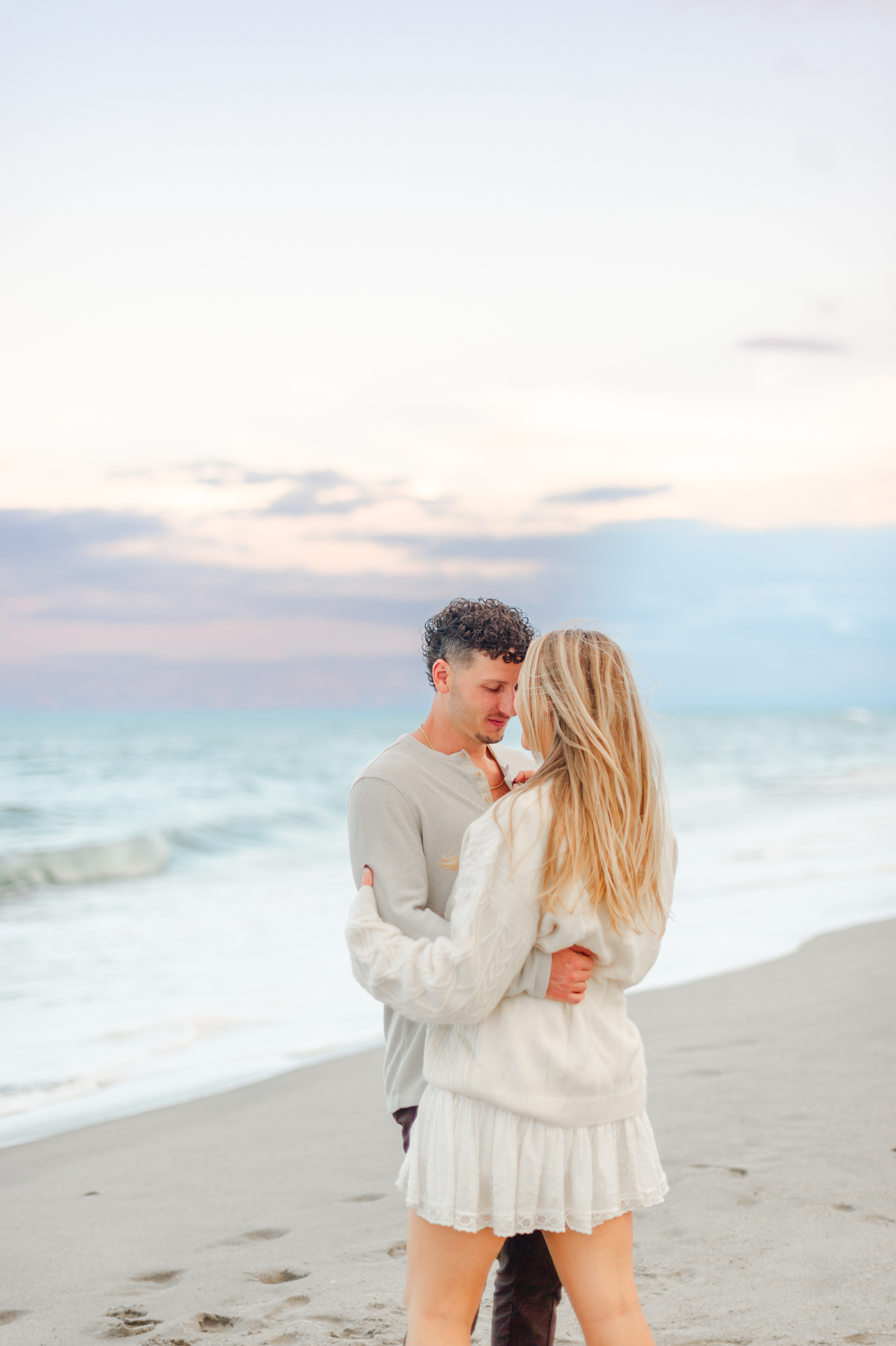 Couple forehead to forehead near the shoreline during a beautiful Florida sunset A Picnic Affair