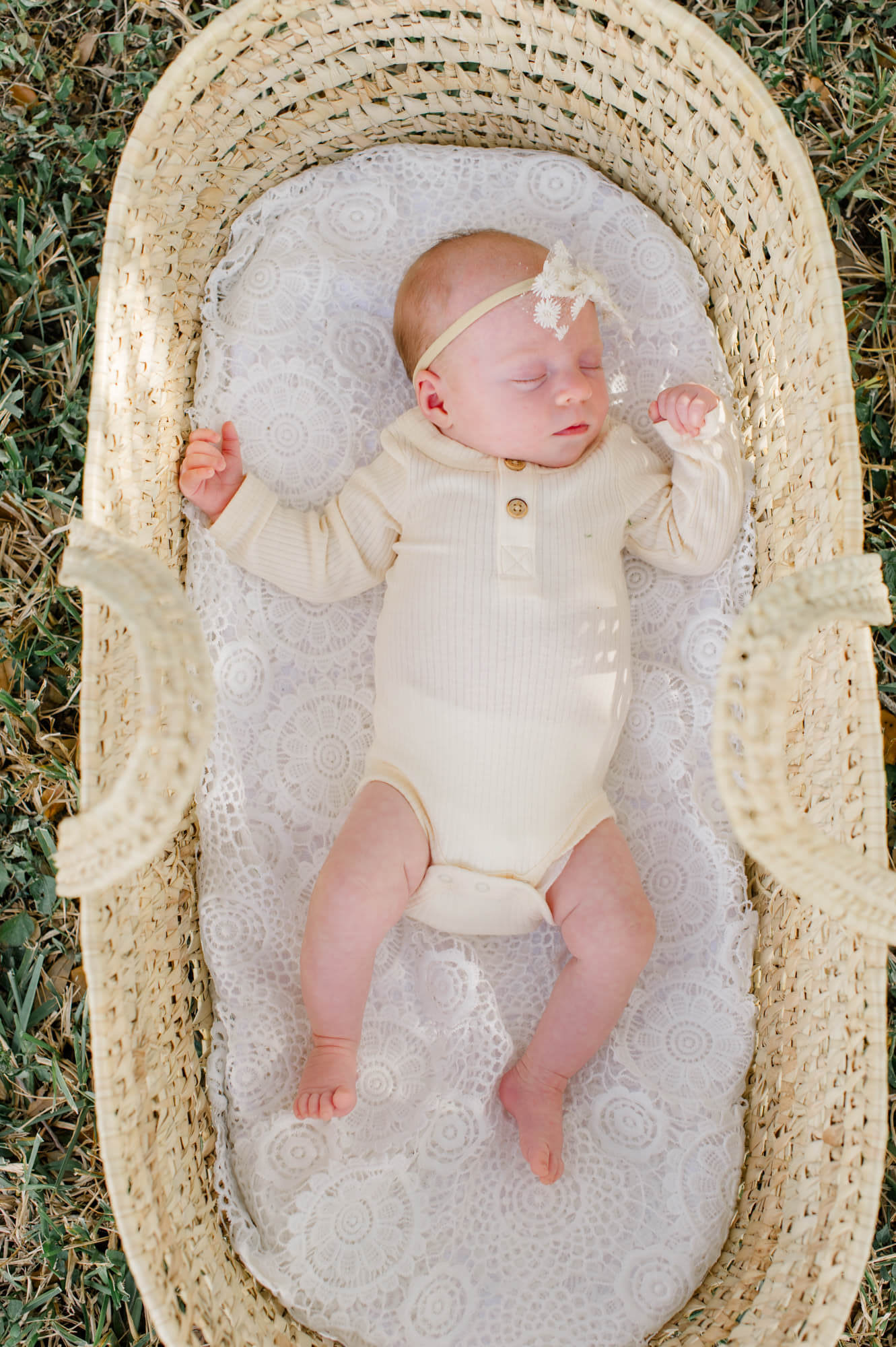 Beautiful newborn baby in neutral colors with a wicker basket Hibiscus Women's Center