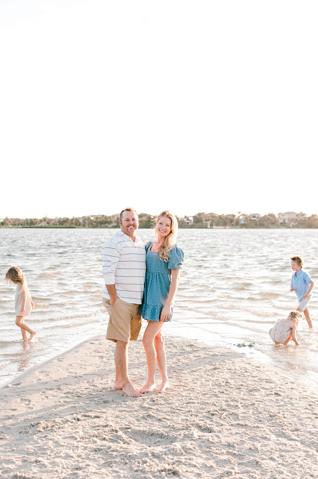 Kids play in the water while mom and dad pose for a photo on Bird Island on Florida's Space Coast. 
