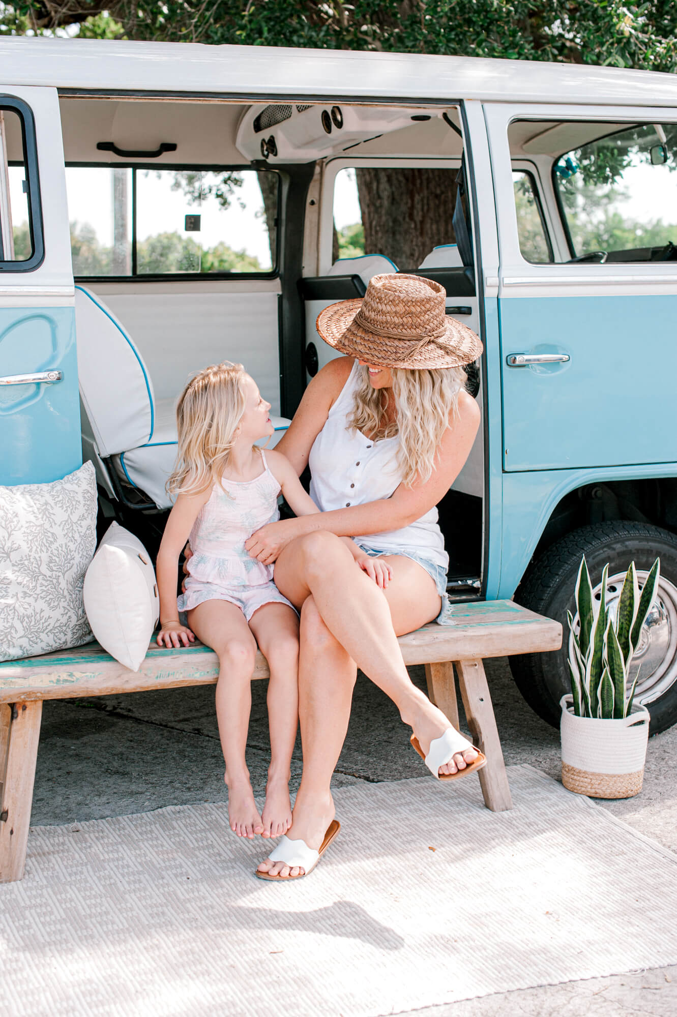 Stunning image of a beach mom and daughter sitting in front of a VW bus together during their motherhood session Pediatric dentists in Orlando