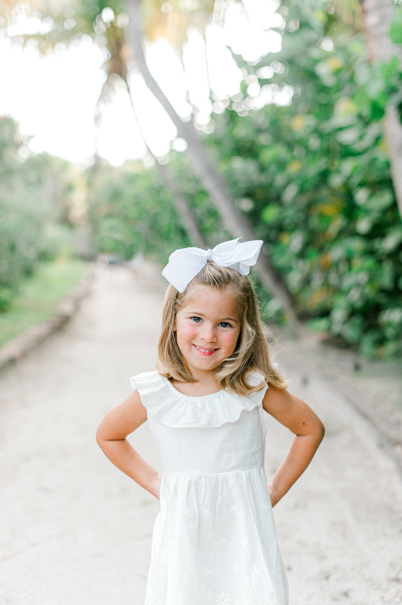 Young daughter posing on a beach path east of Orlando during their family photoshoot