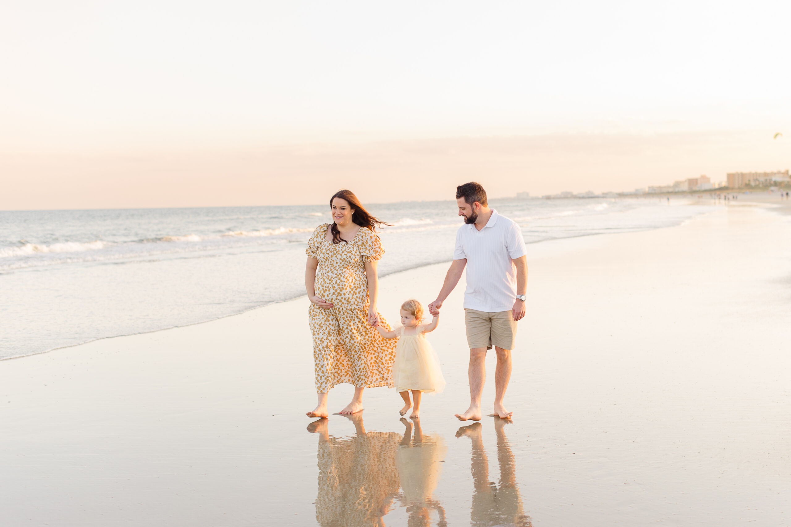 Family walking along the beach at sunset VPK Orlando