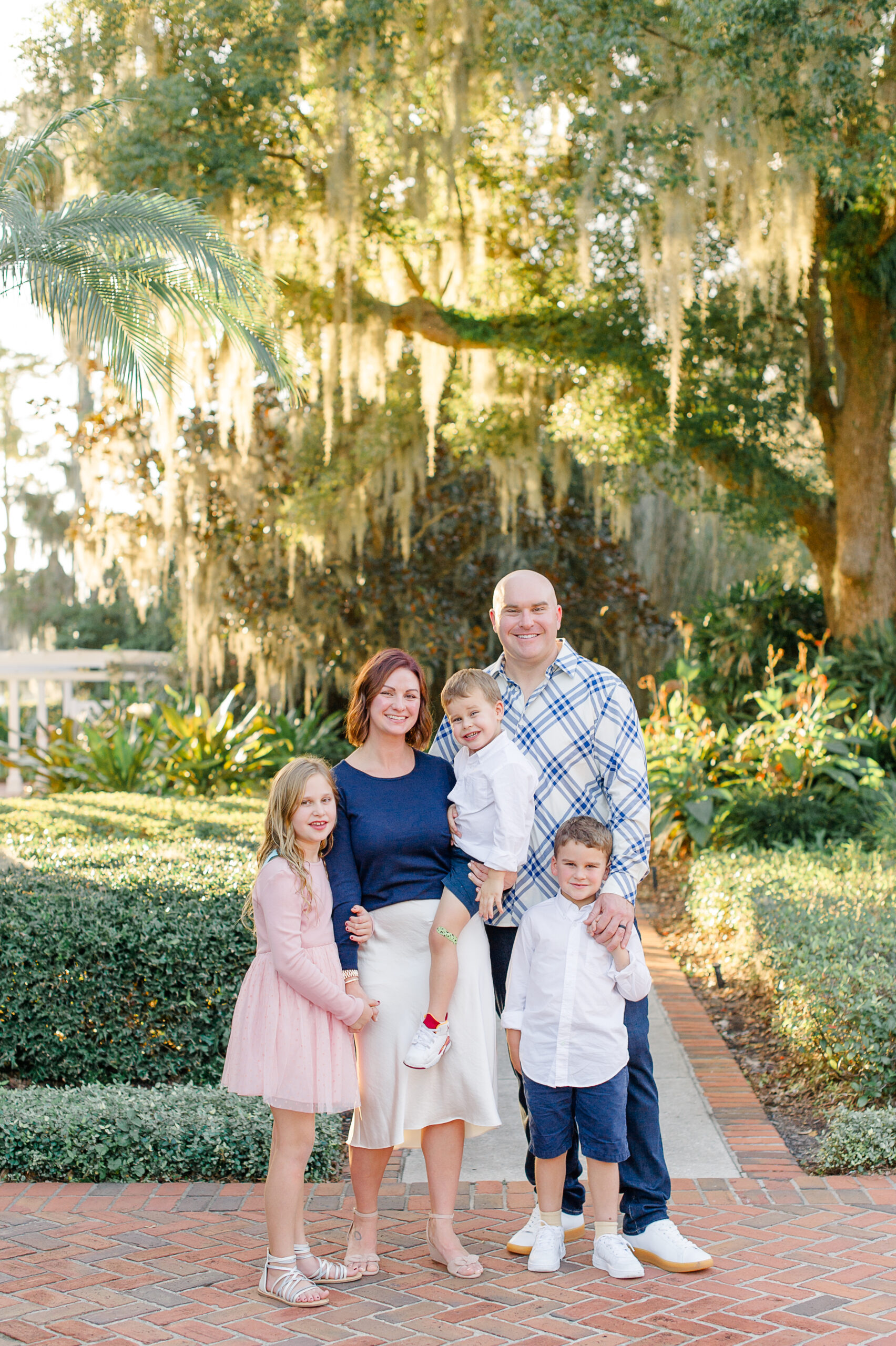 Family of five standing in the beautiful Cypress Grove Park in Orlando !